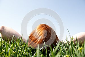 Redhead Laying In Grass Looking Up