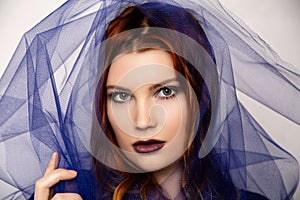 Redhead model surrounded by tulle