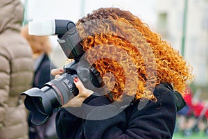 Redhead photographer woman with professional camera