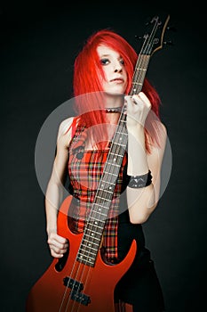 Redhead rocker girl with guitar