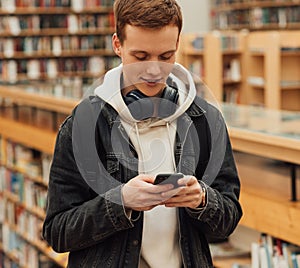 Redhead student typing on a smartphone