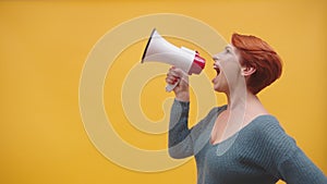 Redhead woman in 40s speaking in loudspeaker