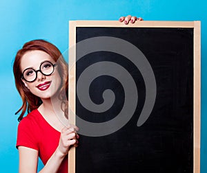 Redhead woman with blackboard