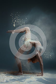 Redhead woman dancer in dust