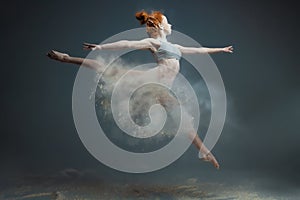 Redhead woman dancer in dust