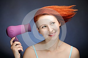 Redhead woman drying her hair