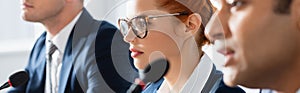 Redhead woman in eyeglasses, sitting near