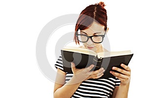 Redhead woman with glasses reading a book