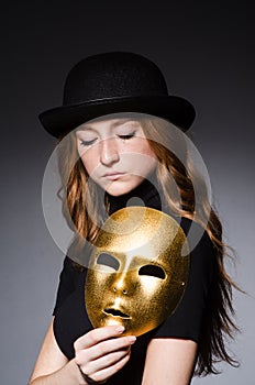 Redhead woman in hat iwith mask in hypocrisy consept