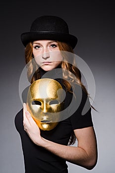 Redhead woman in hat iwith mask in hypocrisy consept