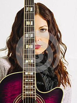 Redhead woman holding acoustic guitar