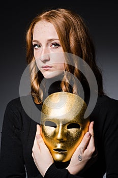 Redhead woman iwith mask in hypocrisy consept against
