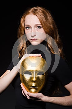 Redhead woman iwith mask in hypocrisy consept against photo
