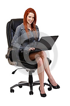 Redhead woman with laptop sitting on chair