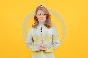 redhead woman in queen crown with magic wand, wish