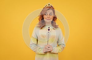 redhead woman in queen crown with magic wand, wish