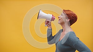 Redhead woman in 40s speaking in loudspeaker