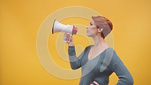 Redhead woman in 40s speaking in loudspeaker