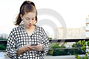 Redhead woman sending message with smartphone