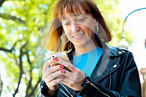 Redhead woman sending message with smartphone
