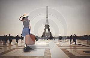 Redhead woman with suitcase come to Paris