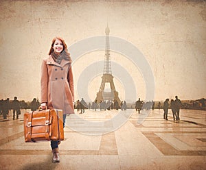 Redhead woman with suitcase come to Paris