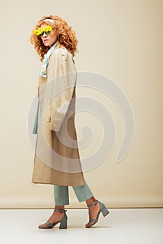 Redhead woman in sunglasses with flowers