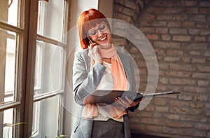 Redhead woman talking on cell phone