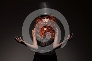 Redhead woman wearing black bowler hat