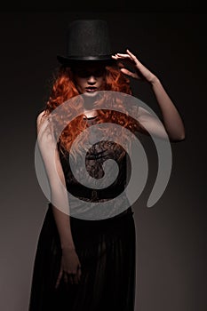 Redhead woman wearing black bowler hat