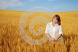 Redhead woman in wheat field