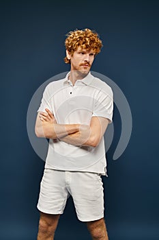 redhead young man in white polo photo