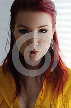 The redhead young woman in yellow shirt portrait