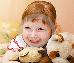 Redheaded child with teddy bears