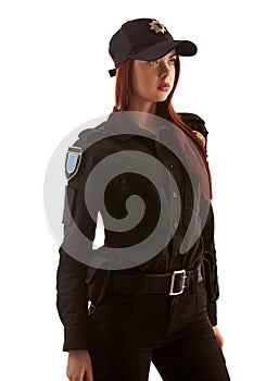 Redheaded female police officer is posing for the camera isolated on white background.