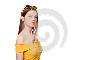 Redheaded female in yellow top and sunglasses