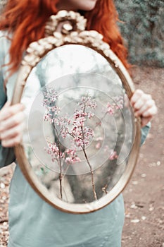 Redheaded Woman Holding Gold Mirror