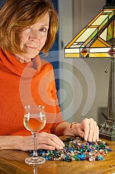 Redheaded woman sorting beads