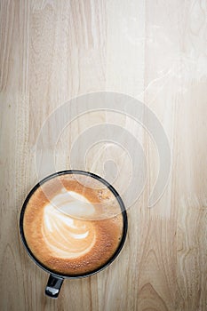 Redolent cappuccino coffee on wooden table. Selective focus.