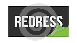 REDRESS text written on black green sticker