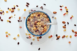 Reduce callories. Top view of muesli bowl with dry fruits. photo