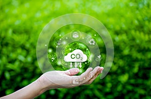 Reduce CO2 emission concept. Environmental icons in hand. Carbon footprint environment, Renewable clean, and Sustainable energy,