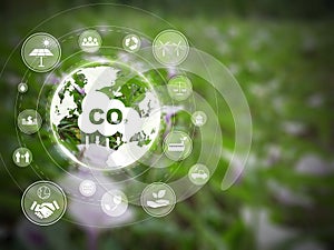 Reduce CO2 emission concept with refreshing green field in the background. Many icons on helping reduce the carbon dioxide in the