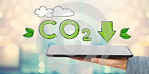 Reduce CO2 with man holding a tablet