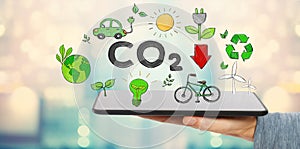 Reduce CO2 with man holding a tablet