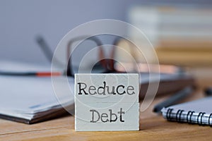 Reduce Debt business text written on wooden chips.