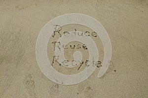 Reduce reuse recycle concept drawn on sand, sustainability