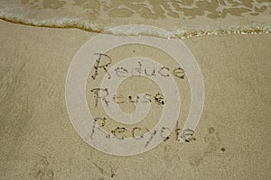 Reduce reuse recycle concept drawn on sand, sustainability