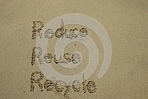 reduce reuse recycle concept drawn on sand, sustainability