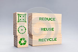 Reduce Reuse Recycle Icons and words on wooden blocks